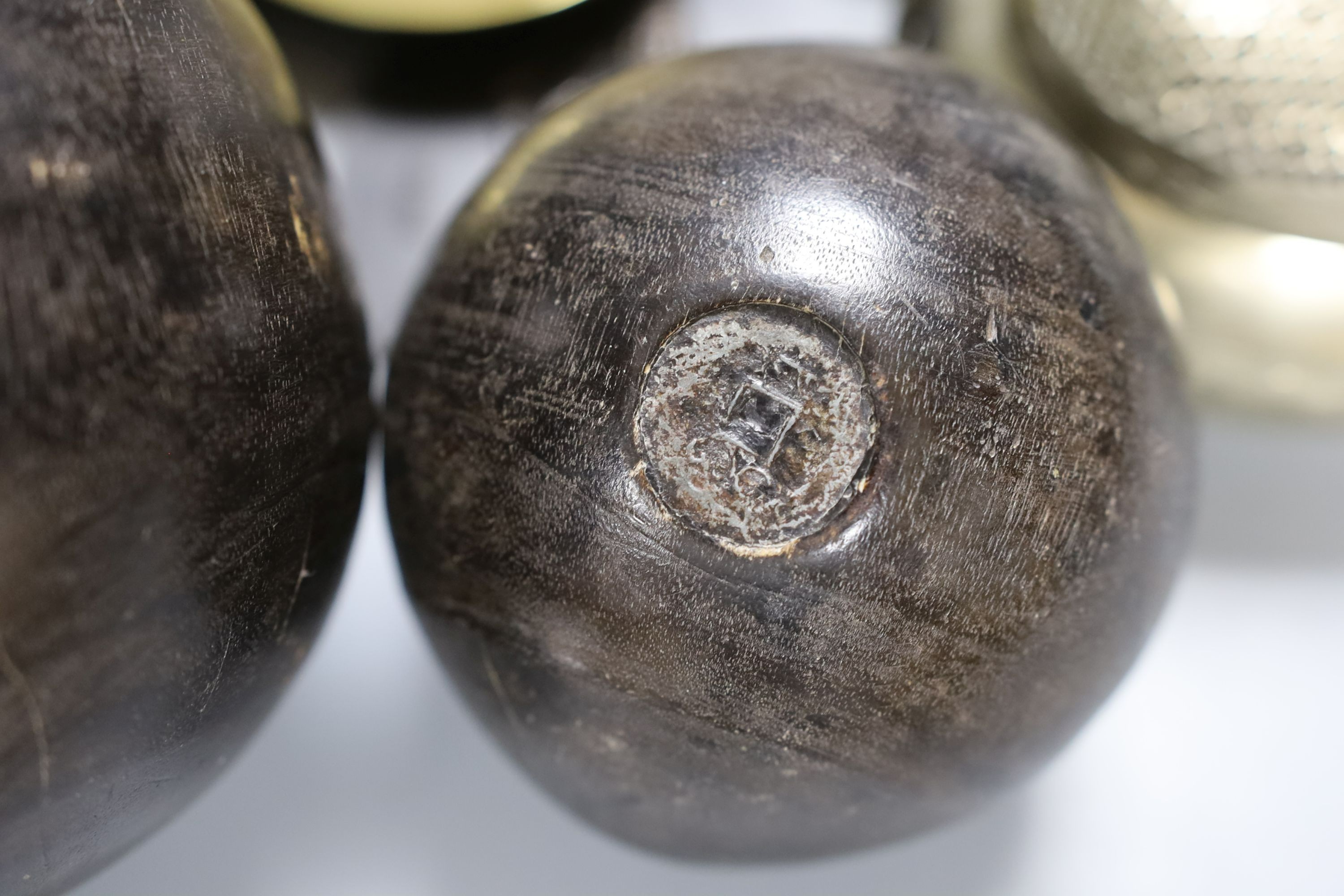 Metalware to include - a Sino-Tibetan bronze amulet, a Bidri ware dish, a Chinese paktong handwarmer Asian wood balls with inset coins etc